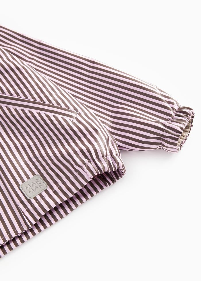 Rain jacket sleeve with elastic cuff and pink/brown striped label.