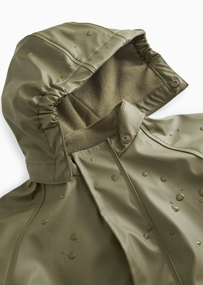 Olive green raincoat with hood and visible water droplets on the smooth surface.