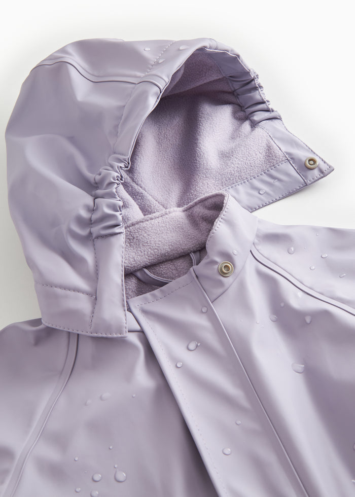 Lavender raincoat with snap closure, visible fleece at the collar and water droplets.
