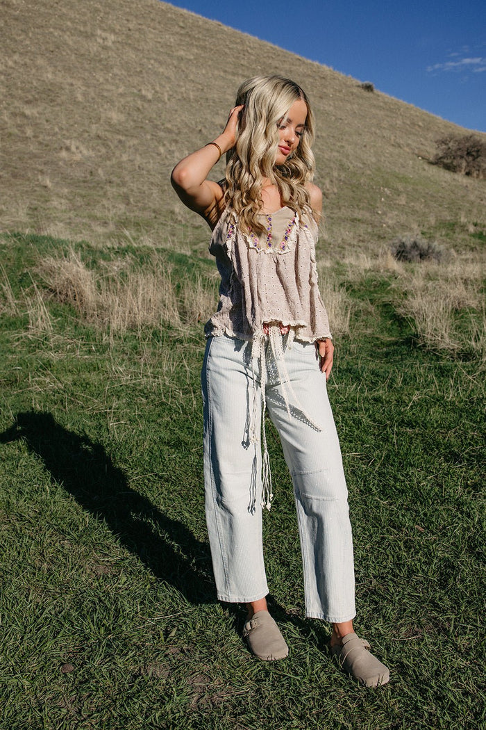 high rise barrel jeans, striped denim women, vintage wash jeans, relaxed fit cropped jeans, paint splash denim, trendy women's denim, horseshoe jeans style