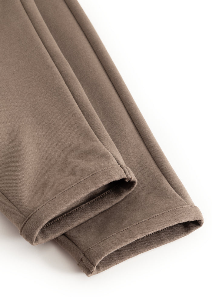Dusty brown pants with double stitching and a narrow hem at the bottom.
