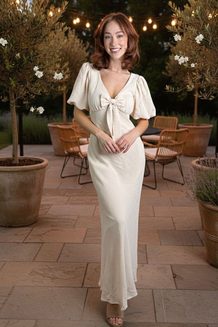 porcelain maxi dress, puff sleeve maxi, bow front dress, wedding guest dress, romantic spring dress, cream maxi dress, v-neck maxi dress, feminine brunch outfit, elegant garden party dress.