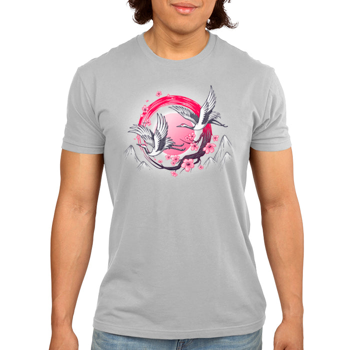 Premium Cotton T-shirt_TeeTurtle Red-Crowned Cranes silver gray t-shirt featuring an illustration of two cranes in flight with pink sakura blossoms, a red circular element, and stylized mountains in the background.