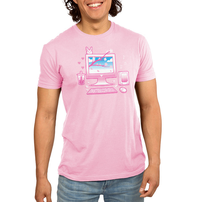 Premium Cotton T-shirt_TeeTurtle Sakura Setup light pink t-shirt featuring pixel art of a desktop computer setup in pink hues. The screen displays cherry blossoms and blue sky. A bubble tea, bunny, and musical notes adorn the scene. A keyboard and mouse are positioned below.