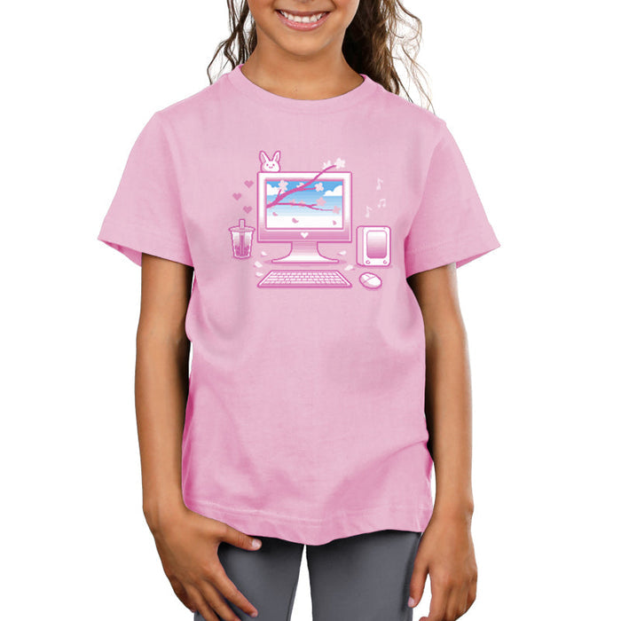 Premium Cotton T-shirt_TeeTurtle Sakura Setup light pink t-shirt featuring pixel art of a desktop computer setup in pink hues. The screen displays cherry blossoms and blue sky. A bubble tea, bunny, and musical notes adorn the scene. A keyboard and mouse are positioned below.