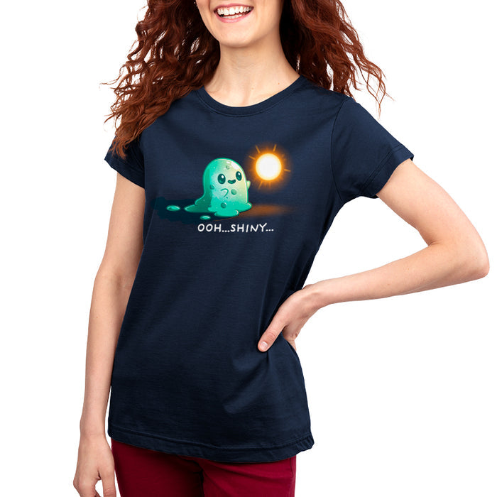 Premium Cotton T-shirt_TeeTurtle Shiny Distraction navy blue t-shirt featuring a slime creature staring in awe at a glowing, golden orb.