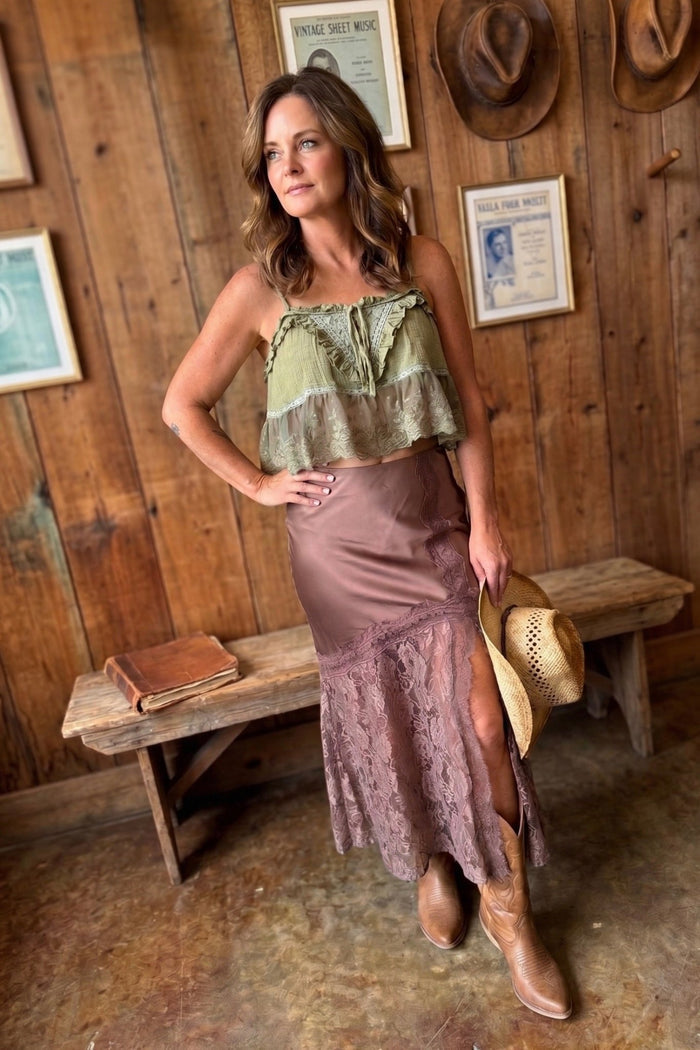 Mocha satin midi skirt with lace trim detailing and side slit styled with western boots for a romantic boho-inspired outfit.