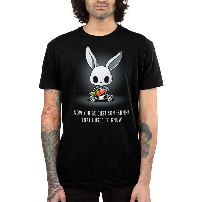 Premium Cotton T-shirt_TeeTurtle black Somebunny That I Used to Know apparel featuring a bunny skeleton sitting down holding a giant carrot with the caption, “Now You’re Just Somebunny That I Used to Know“.
