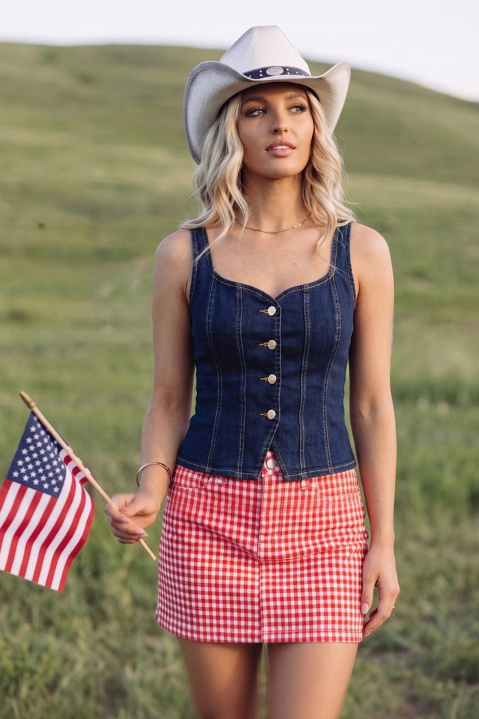 Red gingham mini skirt with a classic checkered pattern, perfect for Fourth of July outfits, country concerts, rodeos, summer festivals, and Americana-inspired boutique fashion.