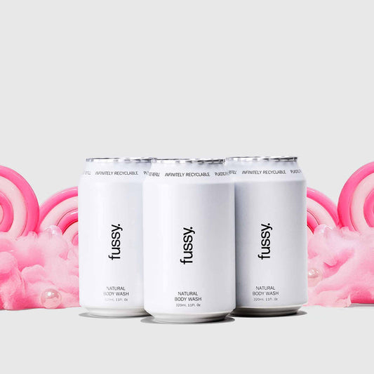 Fussy's Sugar Crush Refill Pack featuring three refills set against a backdrop of pink cotton candy and lollipops.