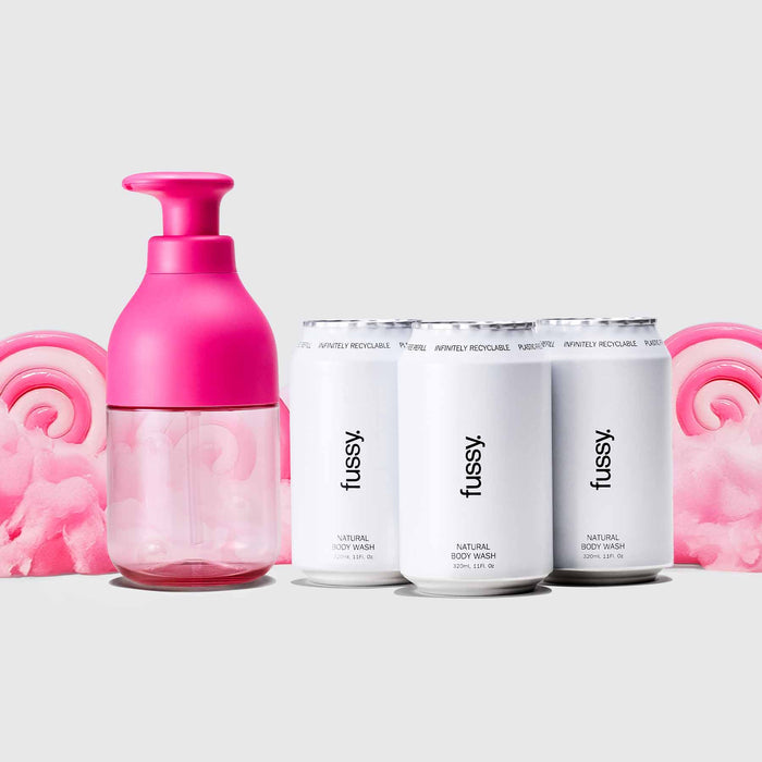 Fussy's Sugar Crush Body Wash Scent pack with Hot Pink refillable bottle, and three refill packs set against a backdrop of pink cotton candy.