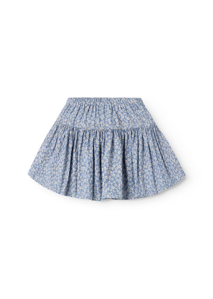 Blue skirt with elastic waist and flowing A-line, small white flowers.