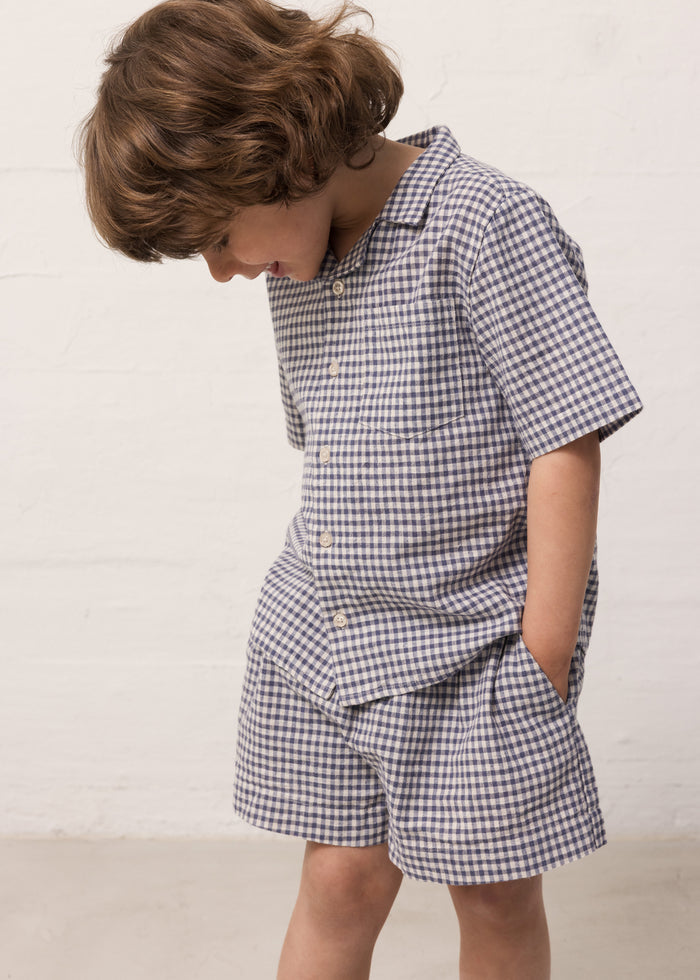 Children wearing a t-shirt and matching shorts.