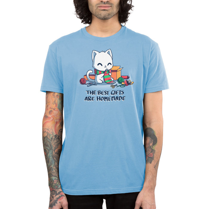 Premium Cotton T-shirt_TeeTurtle light blue The Best Gifts are Homemade apparel featuring a white cat crocheting a red and green scarf, and surrounded by crochet materials, such as crochet hooks, yarn, and a box, with the caption, "The Best Gifts are Homemade".