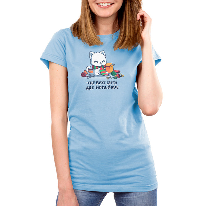 Premium Cotton T-shirt_TeeTurtle light blue The Best Gifts are Homemade apparel featuring a white cat crocheting a red and green scarf, and surrounded by crochet materials, such as crochet hooks, yarn, and a box, with the caption, "The Best Gifts are Homemade".