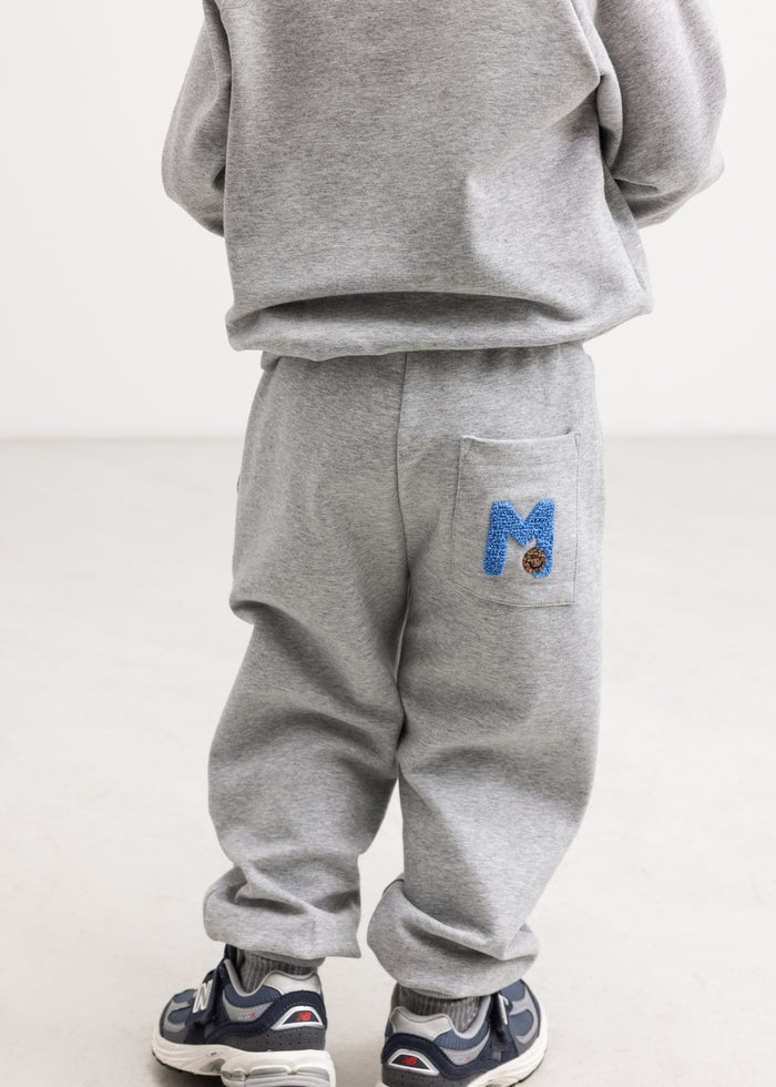 Grey sweatshirt set from the back with ribbing at the bottom and sleeves.